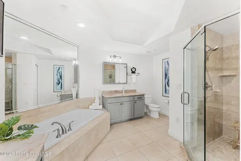 a spacious bathroom with a granite countertop tub sink and mirror