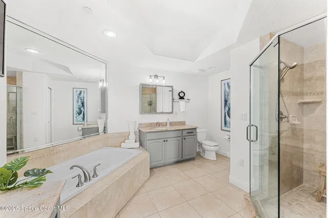 a spacious bathroom with a granite countertop tub sink and mirror