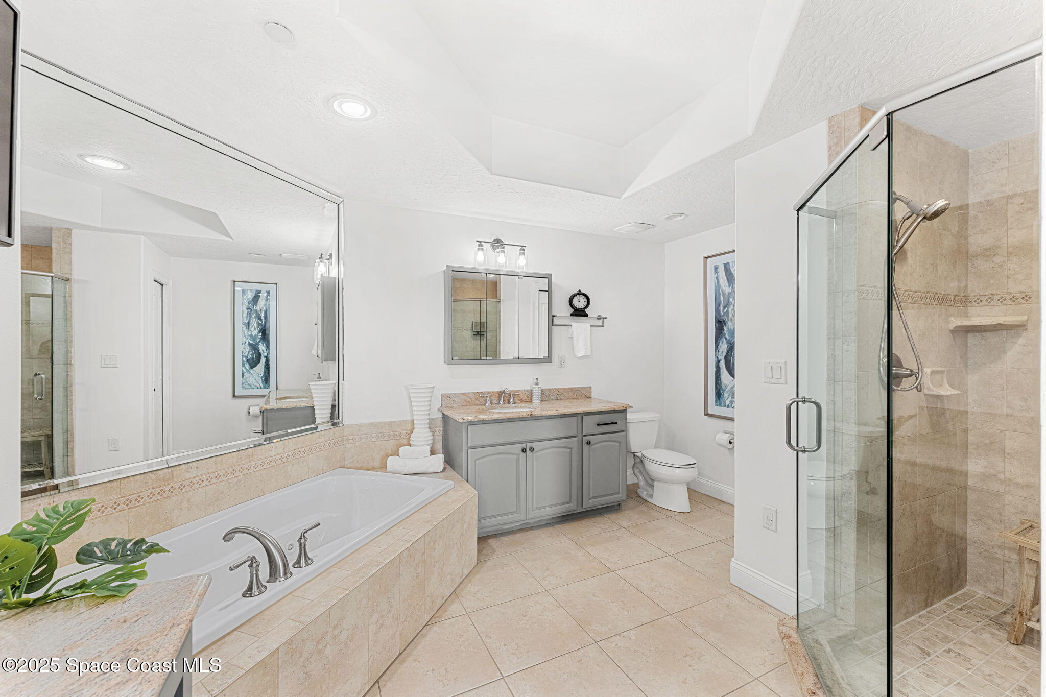 505 South Miramar Avenue, Unit 2403 Indialantic, FL 32903 - Photo 25 of 43 a spacious bathroom with a granite countertop tub sink and mirror