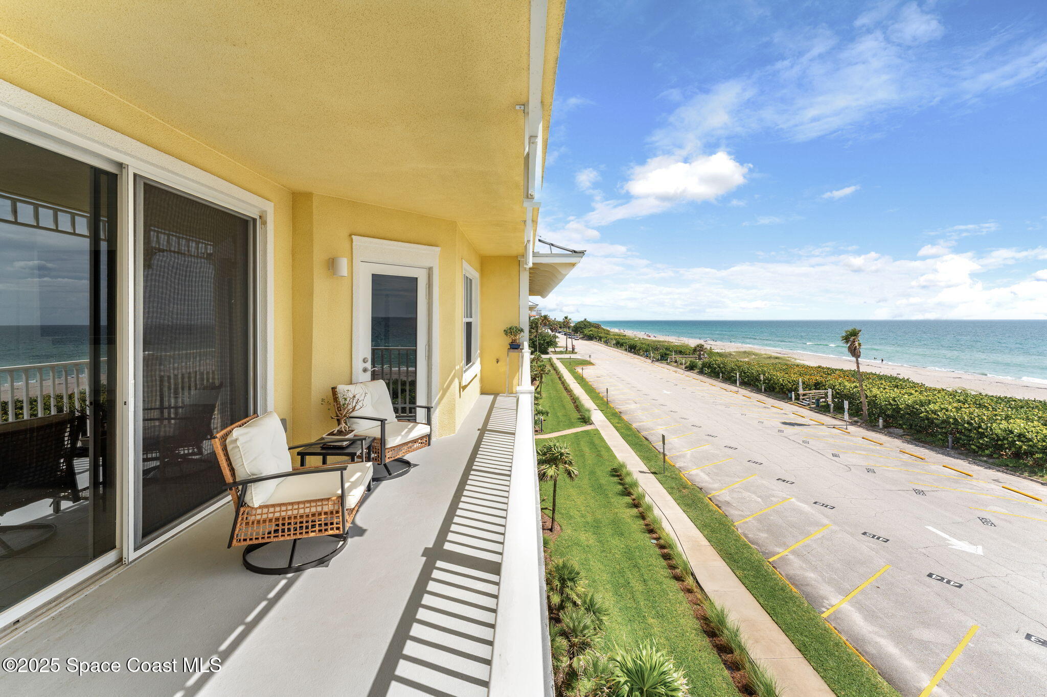 505 South Miramar Avenue, Unit 2403 Indialantic, FL 32903 - Photo 29 of 43 a balcony with wooden floor and outdoor seating