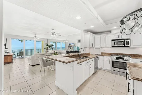 a kitchen with stainless steel appliances granite countertop a stove and cabinets