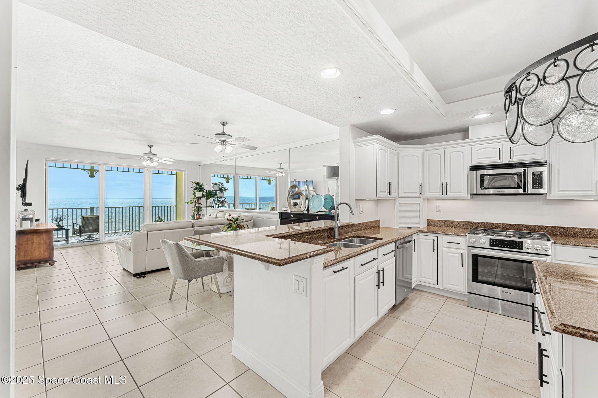 505 South Miramar Avenue, Unit 2403 Indialantic, FL 32903 - Photo 3 of 43 a kitchen with stainless steel appliances granite countertop a stove and cabinets
