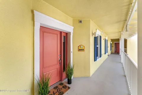 a view of a hallway with wooden shelves