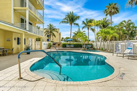a view of a swimming pool with a lounge chair