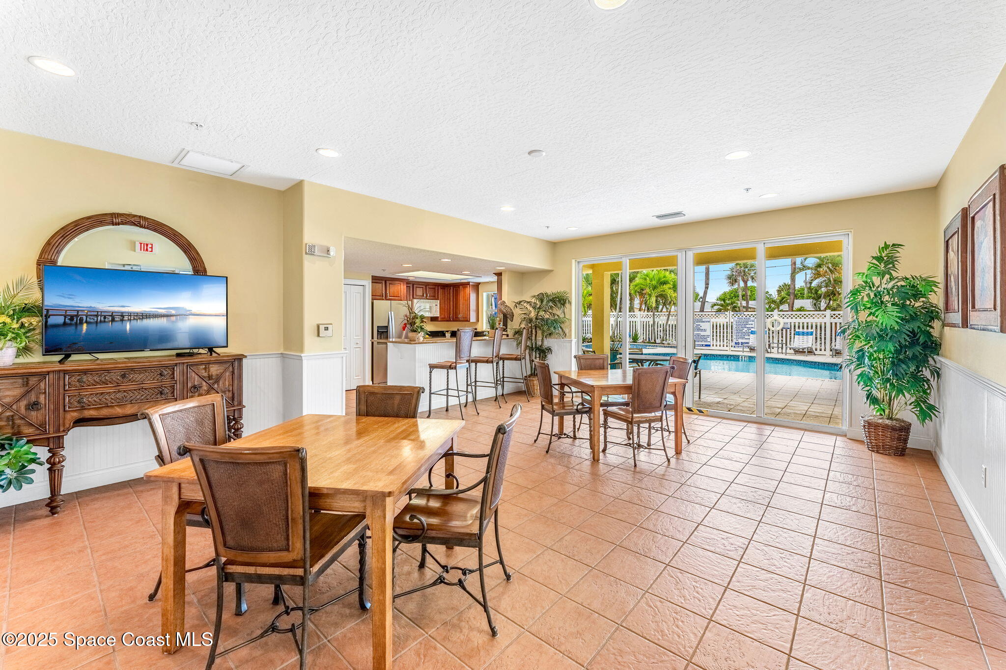 505 South Miramar Avenue, Unit 2403 Indialantic, FL 32903 - Photo 38 of 43 a dining room with furniture and a floor to ceiling window