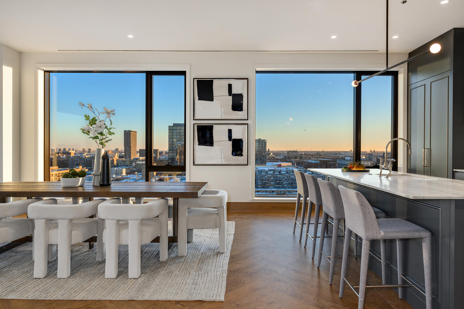 21 North May Street, Unit 1301 Chicago, IL 60607 - Photo 14 of 44 a dining hall with stainless steel appliances kitchen island granite countertop a table chairs and a sink