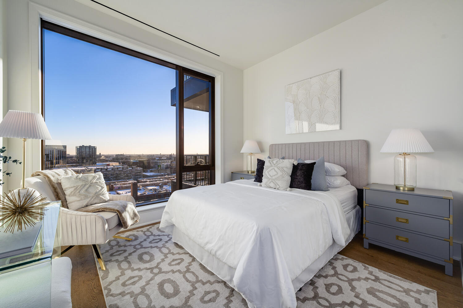 21 North May Street, Unit 1301 Chicago, IL 60607 - Photo 32 of 44 a bedroom with a large bed and a lamp