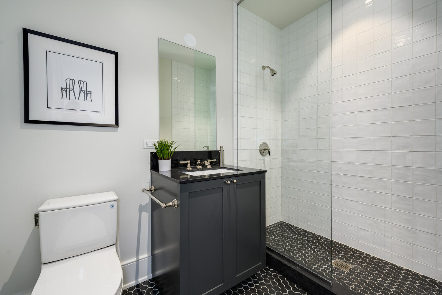 21 North May Street, Unit 1301 Chicago, IL 60607 - Photo 33 of 44 a bathroom with a toilet a sink and a shower