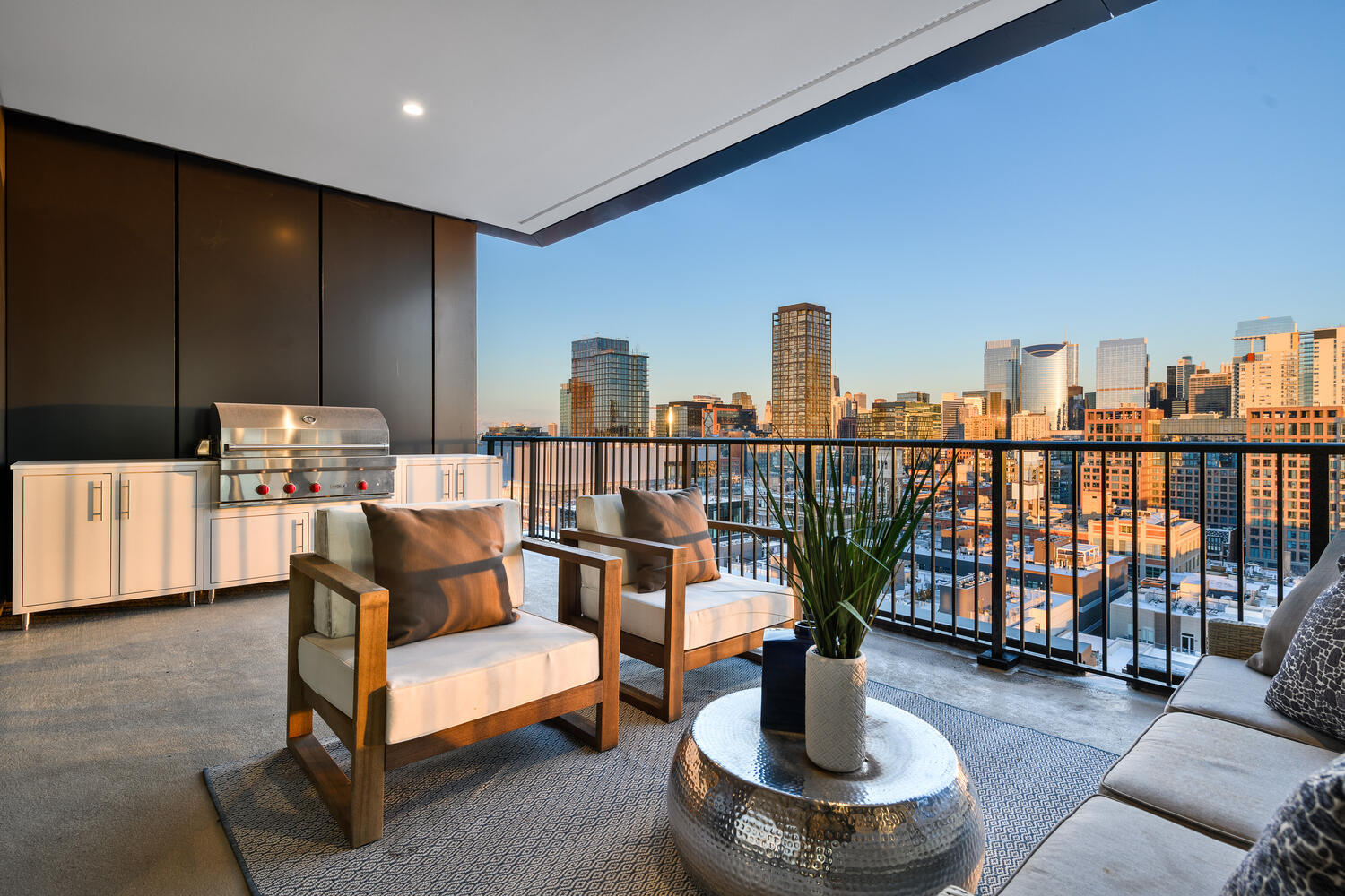 21 North May Street, Unit 1301 Chicago, IL 60607 - Photo 7 of 44 a living room with furniture a flat screen tv and a floor to ceiling window