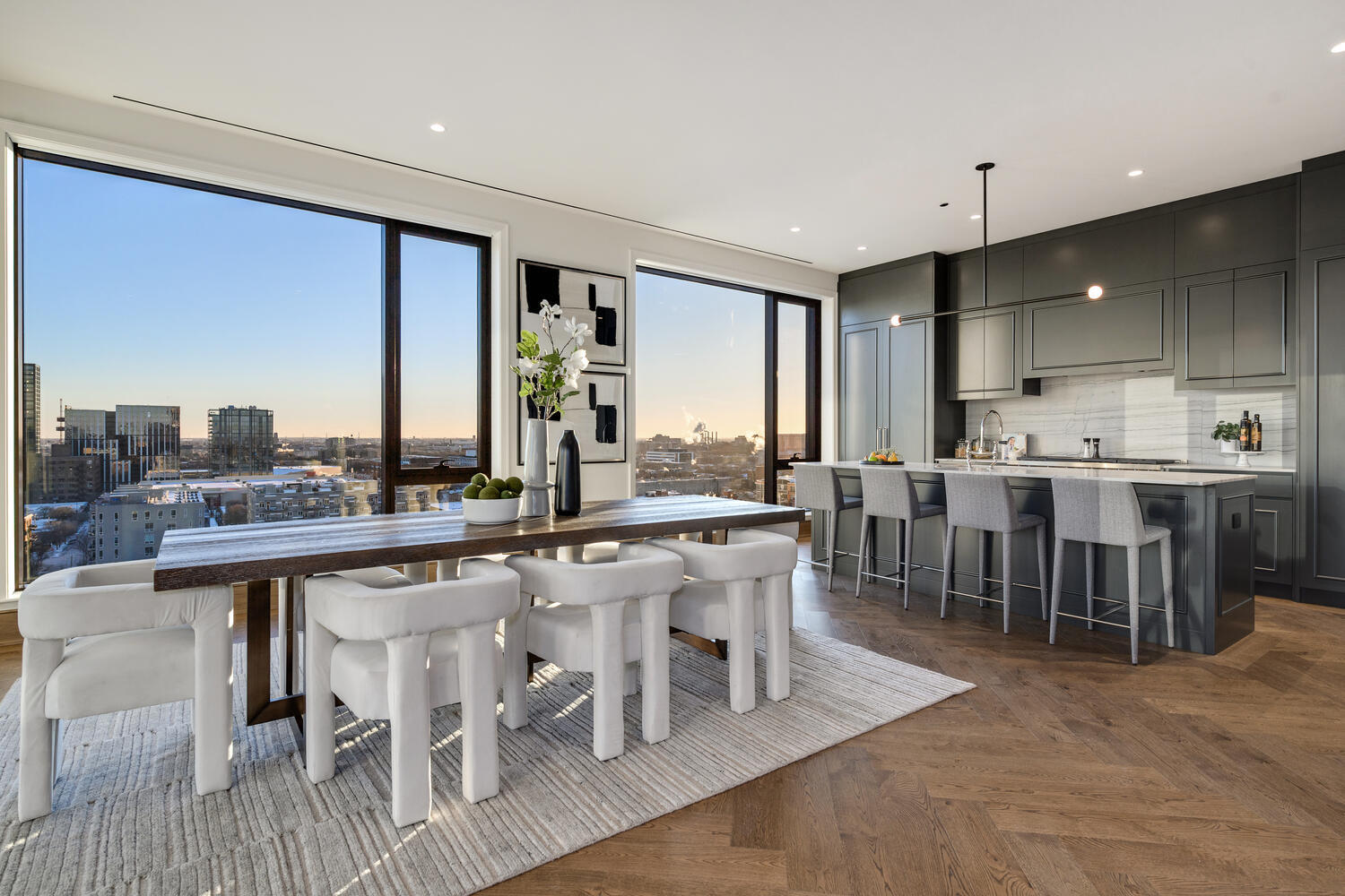 21 North May Street, Unit 1301 Chicago, IL 60607 - Photo 10 of 44 a large dining hall with stainless steel appliances granite countertop a stove a sink a dining table and chairs