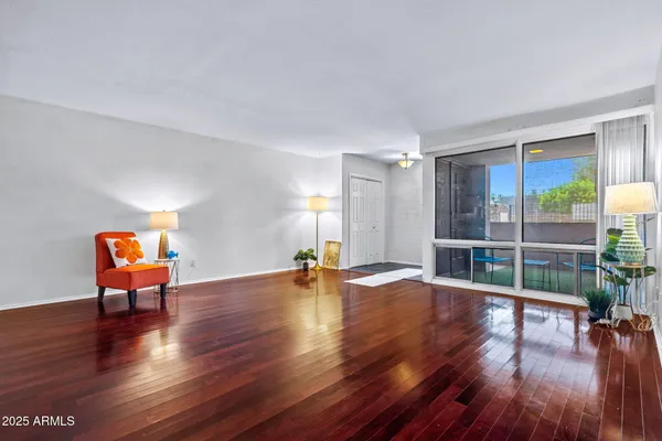 a view of a room with wooden floor and a window
