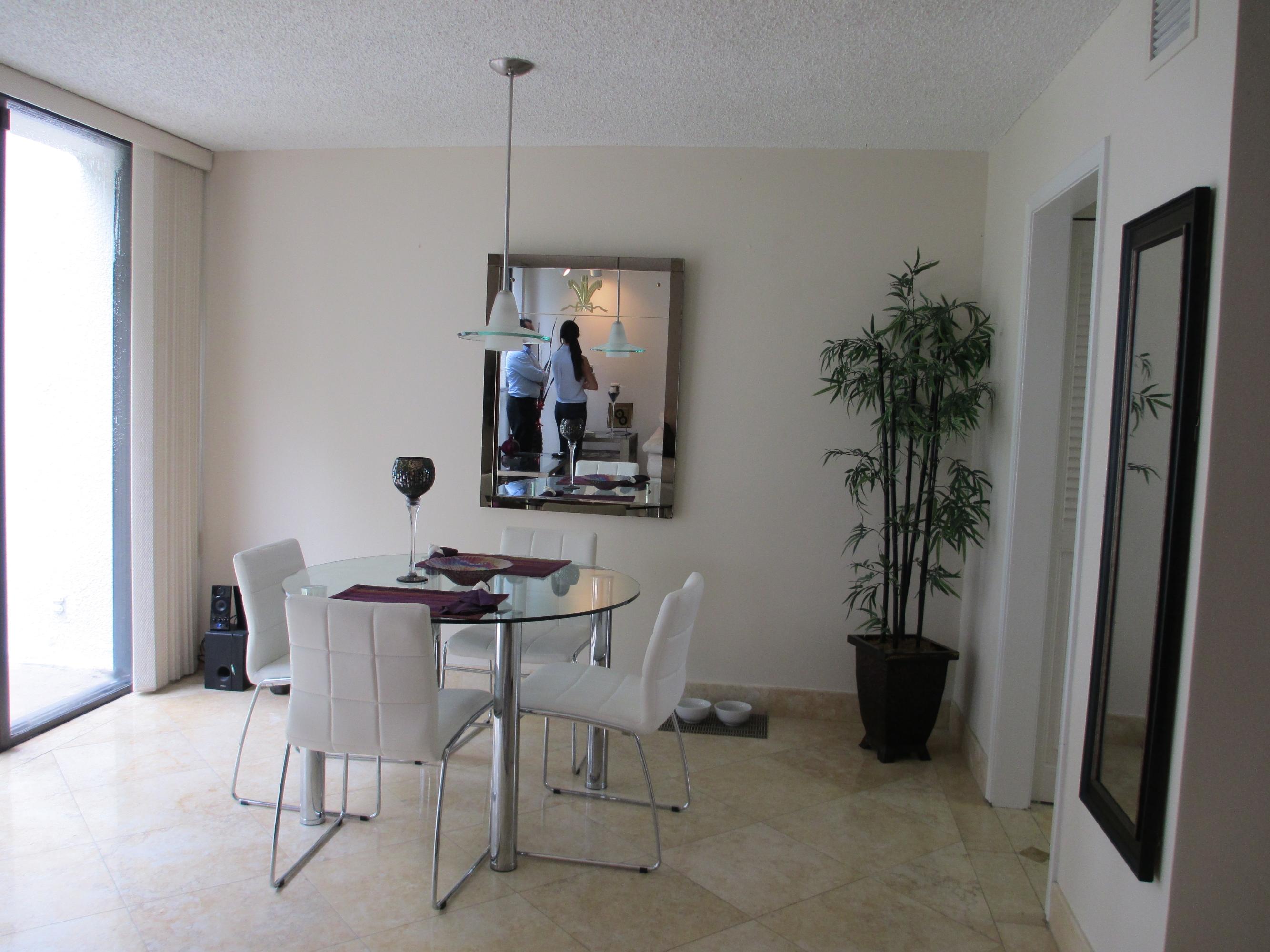 1405 Bridgewood Drive, Unit 1405 Boca Raton, FL 33434 - Photo 17 of 54 a view of a dining room with furniture and a potted plant