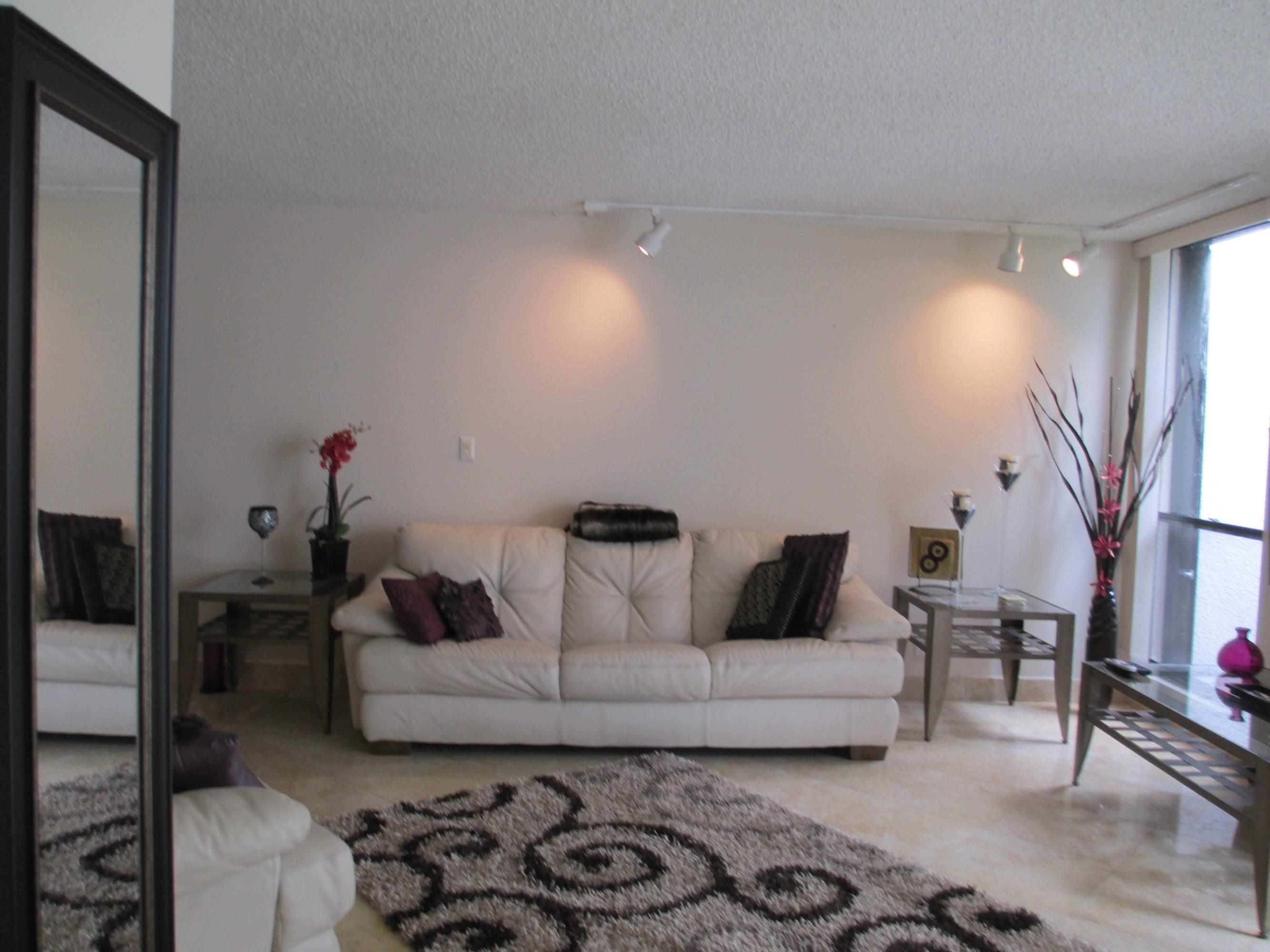 1405 Bridgewood Drive, Unit 1405 Boca Raton, FL 33434 - Photo 10 of 54 a living room with furniture and a fireplace