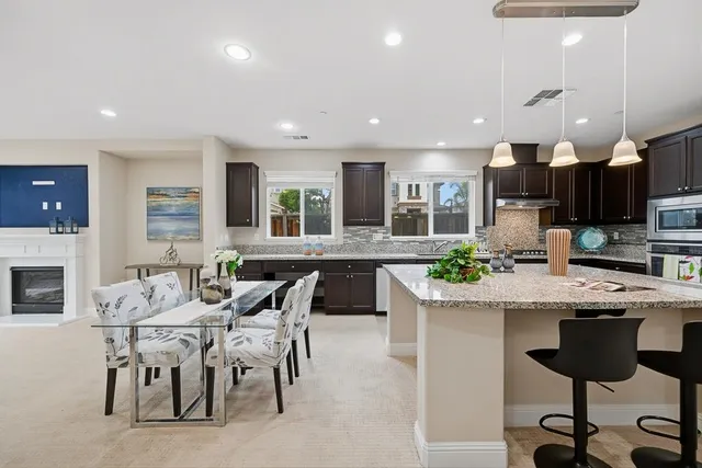 a living room with furniture and large windows