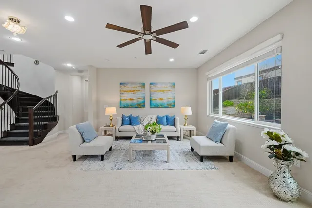 a bedroom with a bed a couch and a window