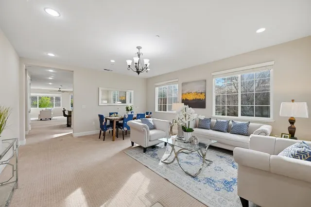 a living room with furniture and a chandelier