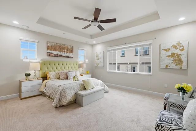 a spacious bathroom with a double vanity sink a large mirror and bathtub
