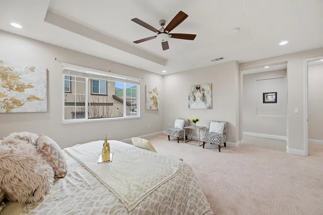 a spacious bathroom with a tub a double vanity sink a mirror and a shower