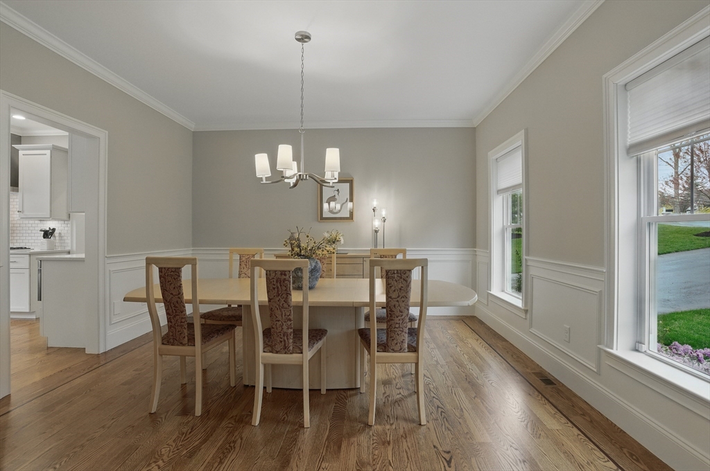 3 Willow Lane Bedford, MA 01730 - Photo 14 of 36 a view of a dining room with furniture a chandelier and wooden floor