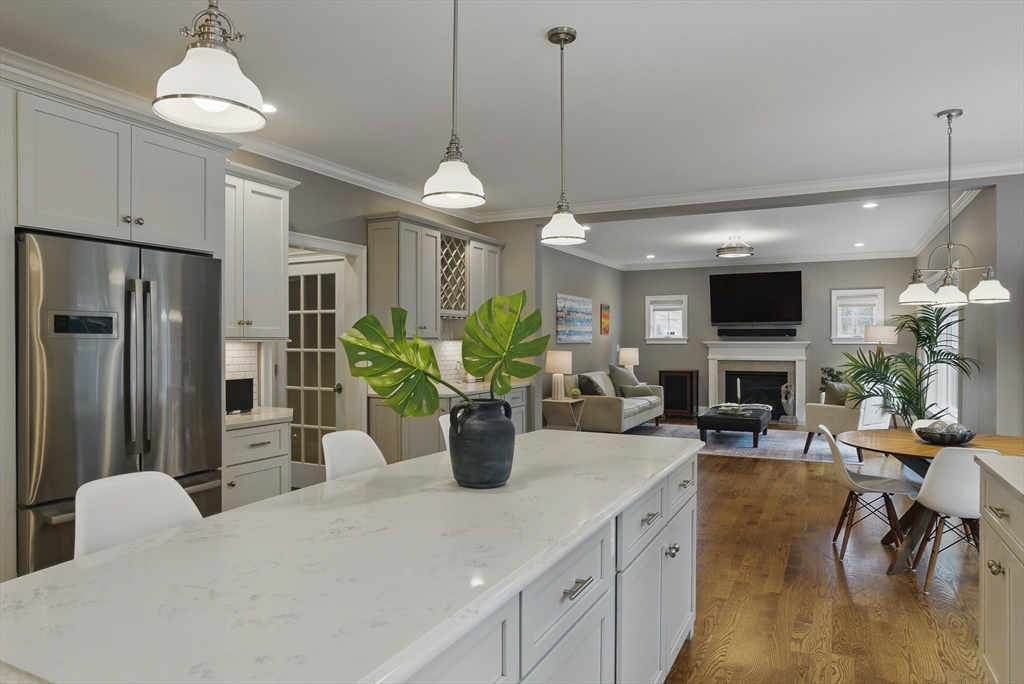3 Willow Lane Bedford, MA 01730 - Photo 2 of 36 a view of a dining room and a livingroom with furniture wooden floor a chandelier