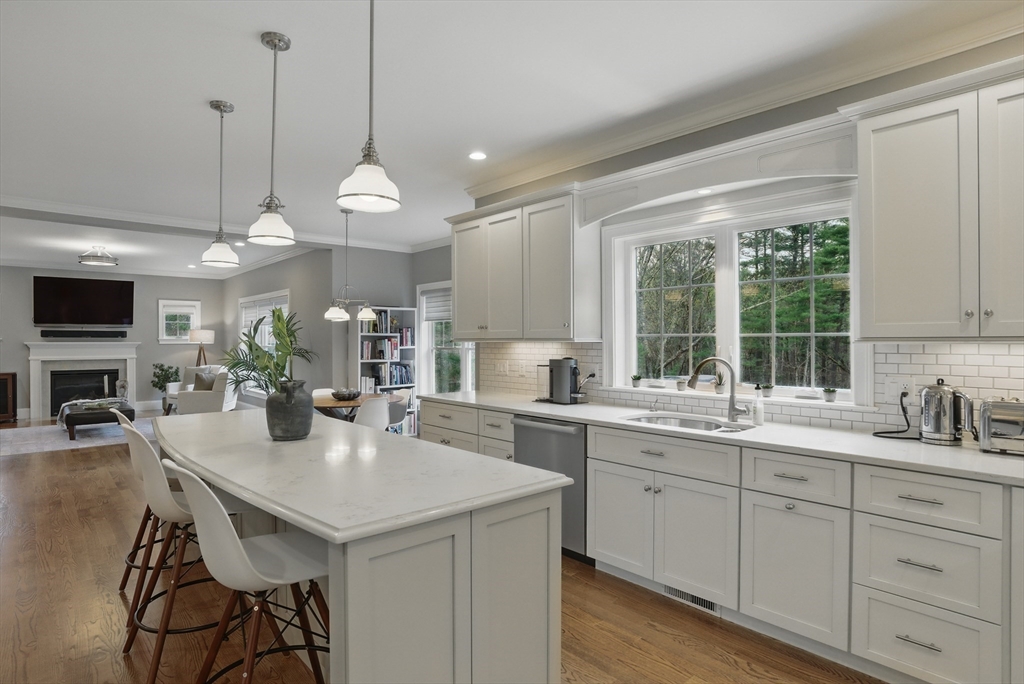 3 Willow Lane Bedford, MA 01730 - Photo 3 of 36 a kitchen with center island and white cabinets