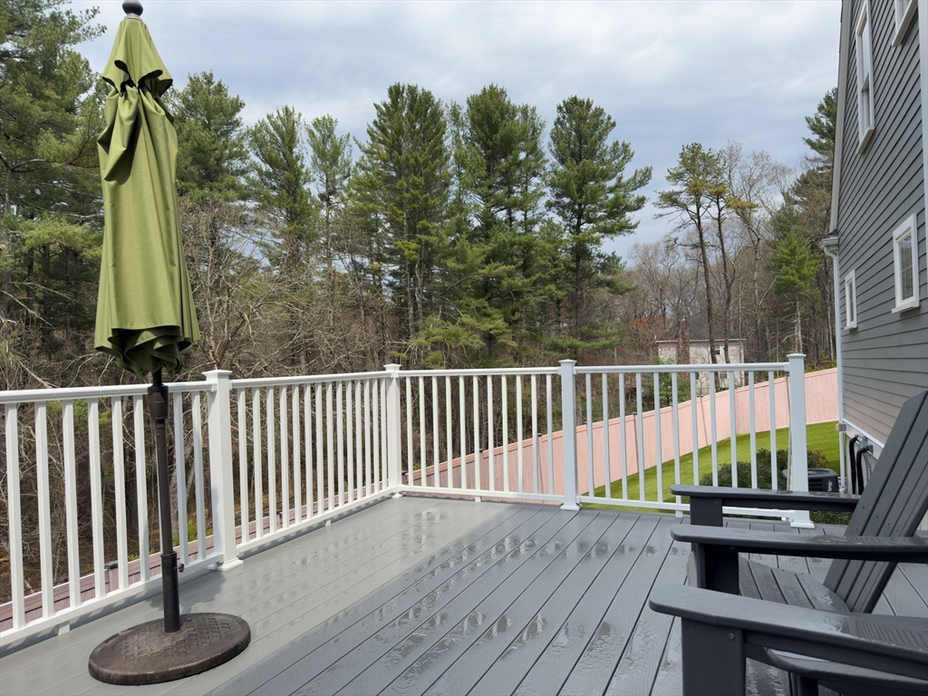 3 Willow Lane Bedford, MA 01730 - Photo 32 of 36 a view of balcony with wooden floor and seating