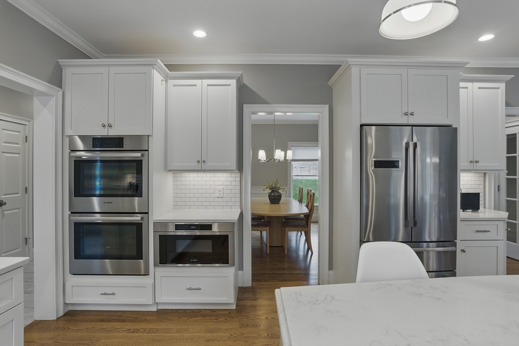 3 Willow Lane Bedford, MA 01730 - Photo 4 of 36 a kitchen with stainless steel appliances kitchen island granite countertop a refrigerator and a stove top oven