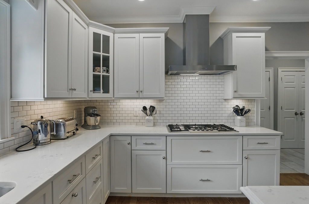 3 Willow Lane Bedford, MA 01730 - Photo 5 of 36 a kitchen with white cabinets and appliances