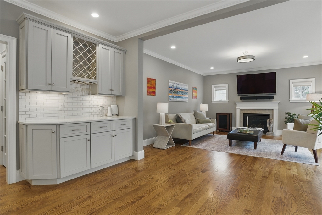 3 Willow Lane Bedford, MA 01730 - Photo 9 of 36 a living room with furniture a fireplace and a flat screen tv