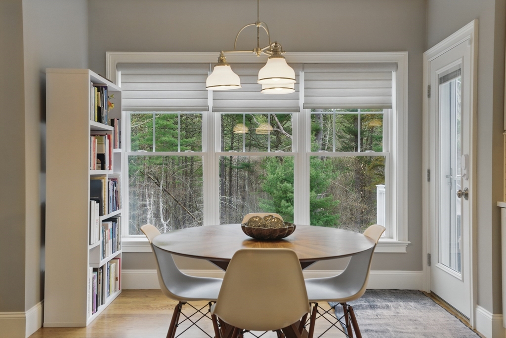 3 Willow Lane Bedford, MA 01730 - Photo 10 of 36 a view of a dining room with furniture wooden floor and a chandelier