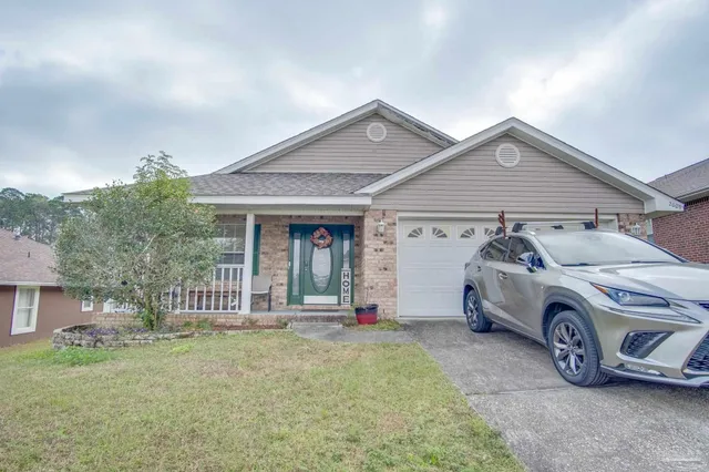 a living room with furniture or chandelier and a wooden floor