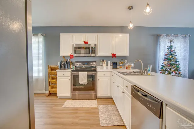 a kitchen with white cabinets and white appliances