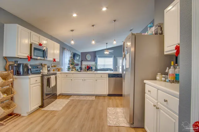 a bathroom with a toilet sink vanity and mirror