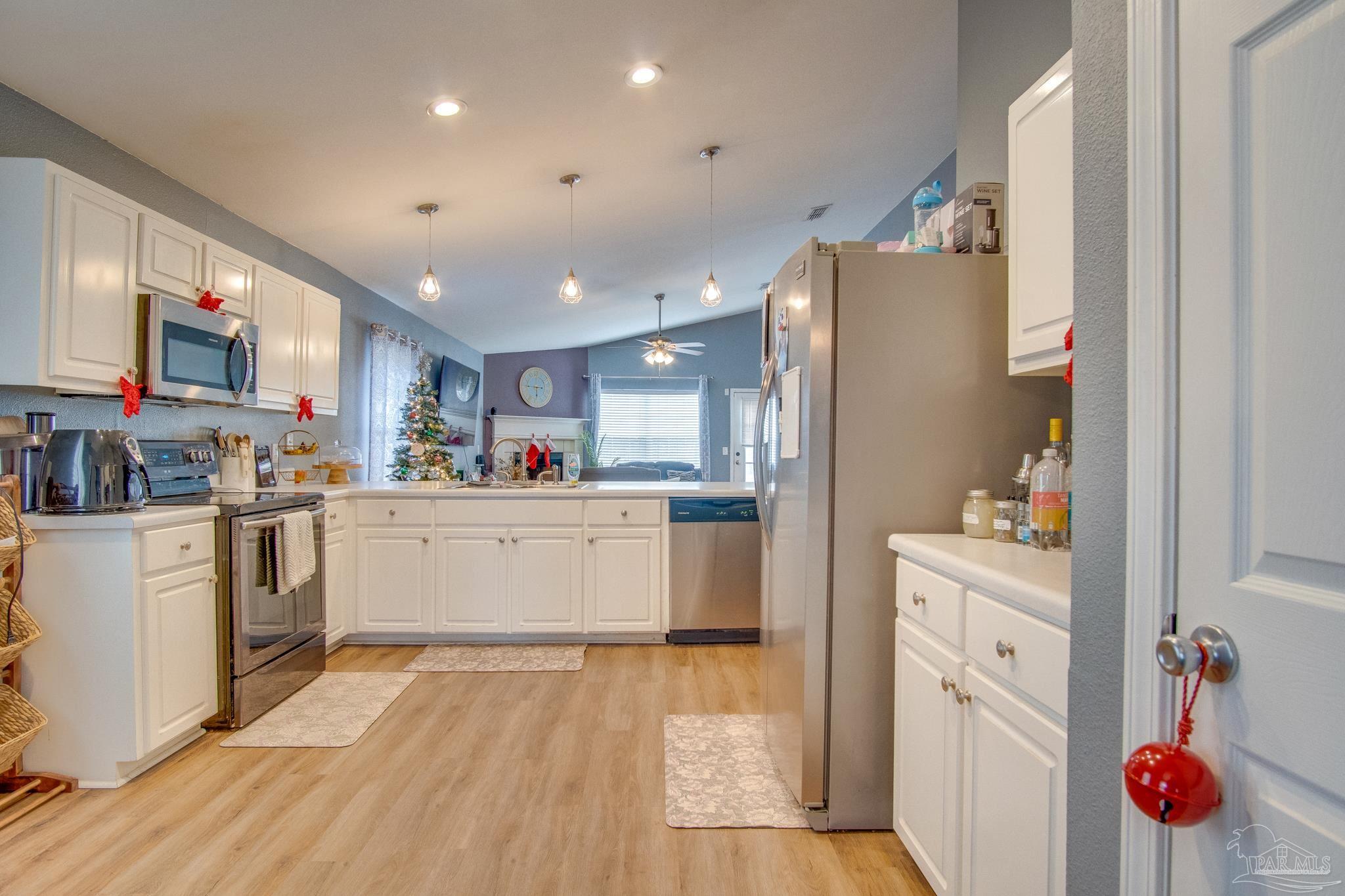 2005 Tujaques Place Pensacola, FL 32505 - Photo 16 of 30 a kitchen with white cabinets and white appliances