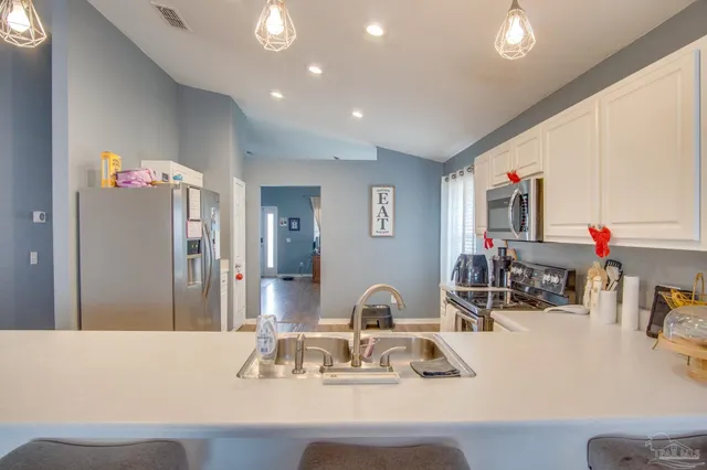 a view of backyard with table and chairs