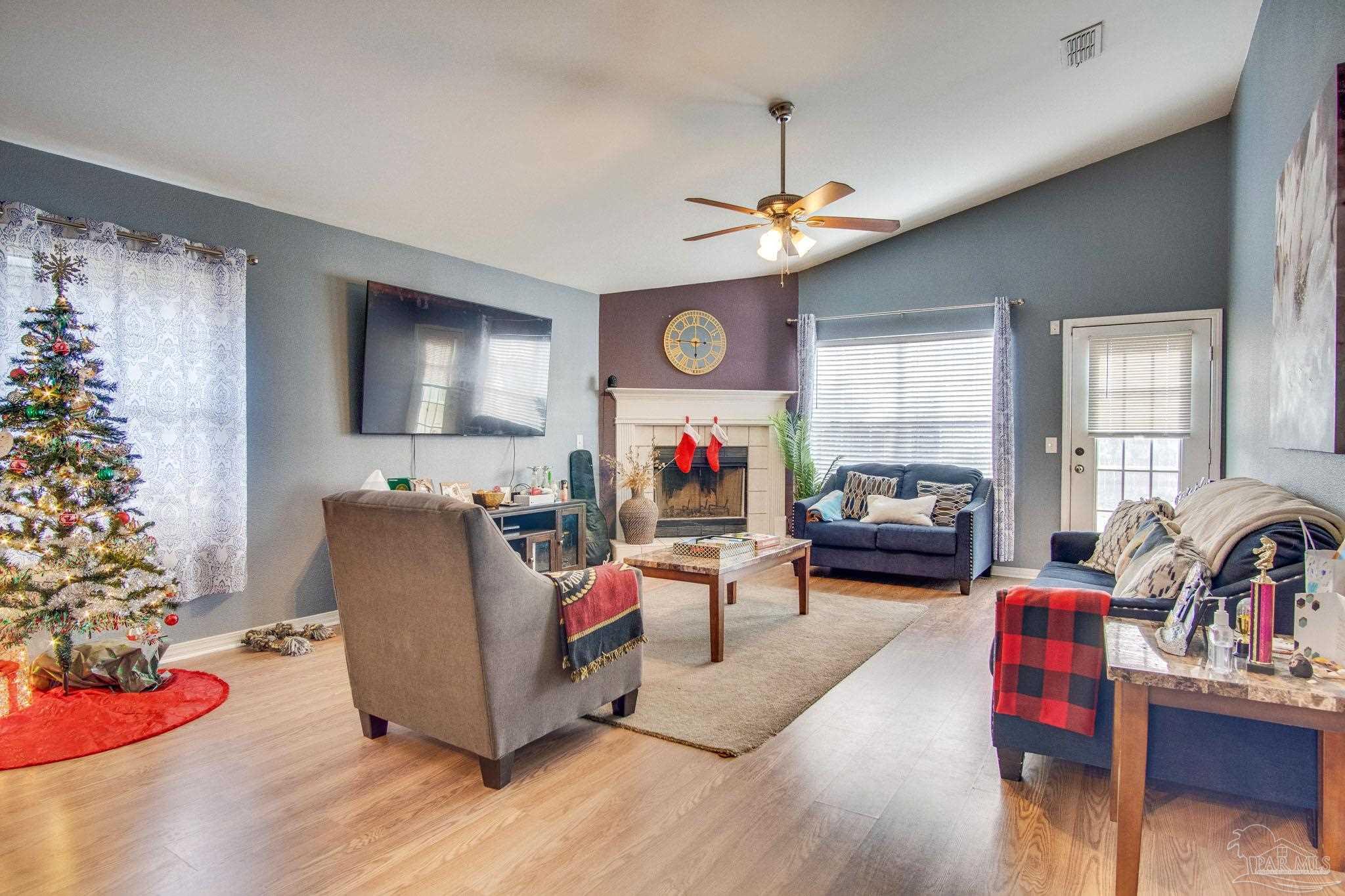 2005 Tujaques Place Pensacola, FL 32505 - Photo 2 of 30 a living room with furniture or chandelier and a wooden floor