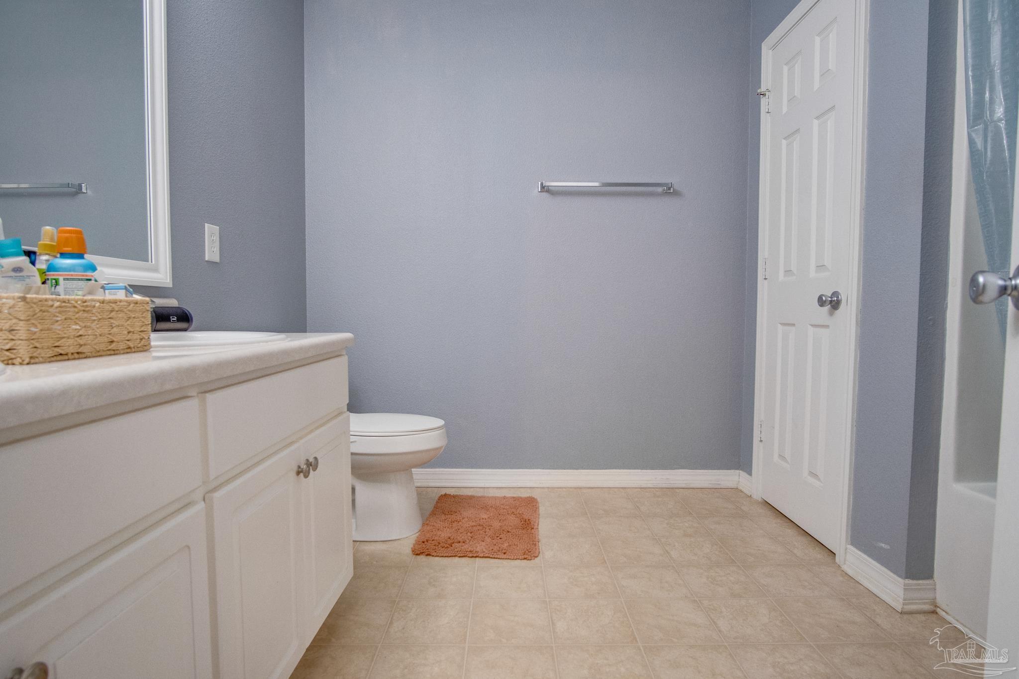 2005 Tujaques Place Pensacola, FL 32505 - Photo 23 of 30 a bathroom with a sink a toilet and mirror
