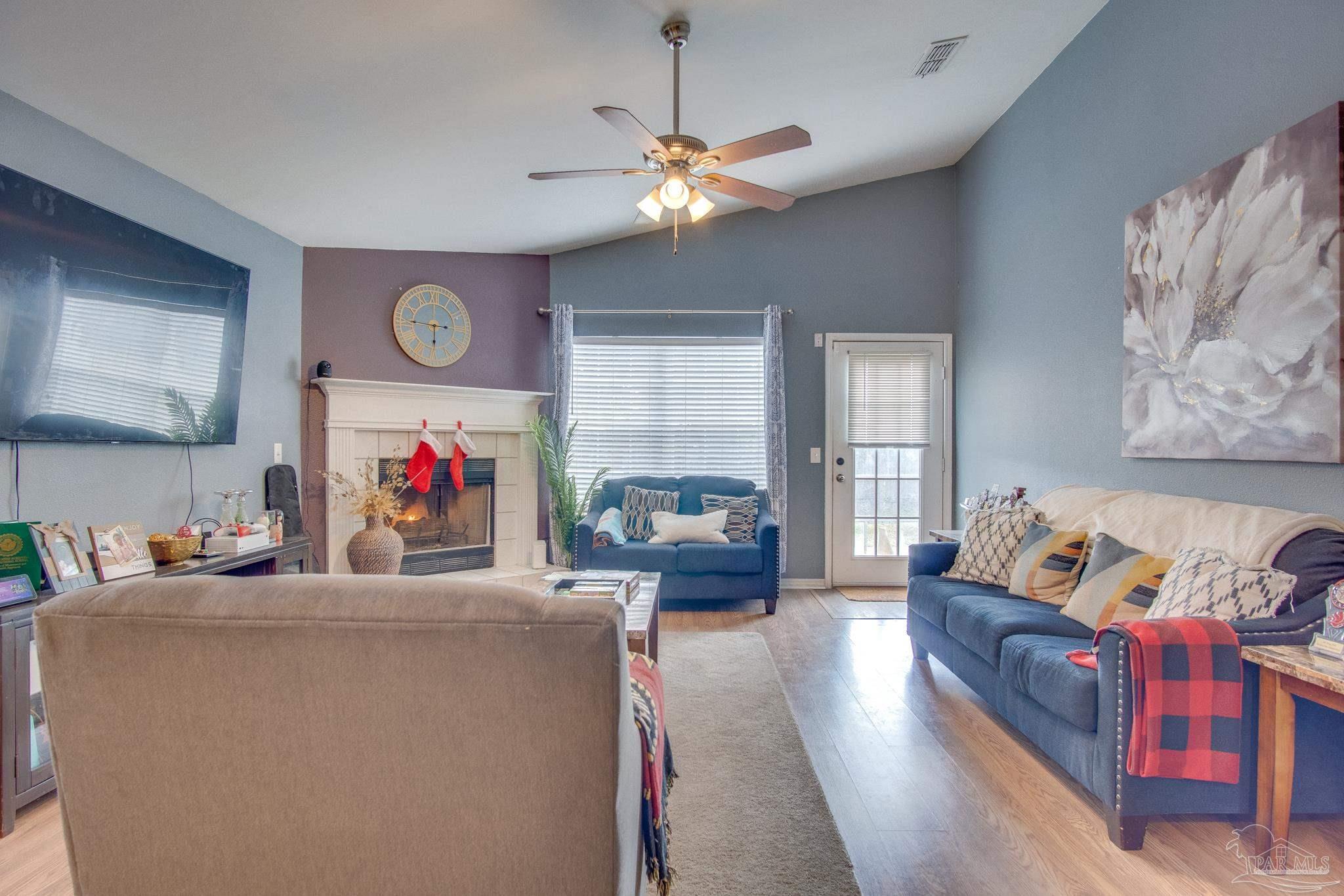 2005 Tujaques Place Pensacola, FL 32505 - Photo 9 of 30 a living room with furniture and a chandelier