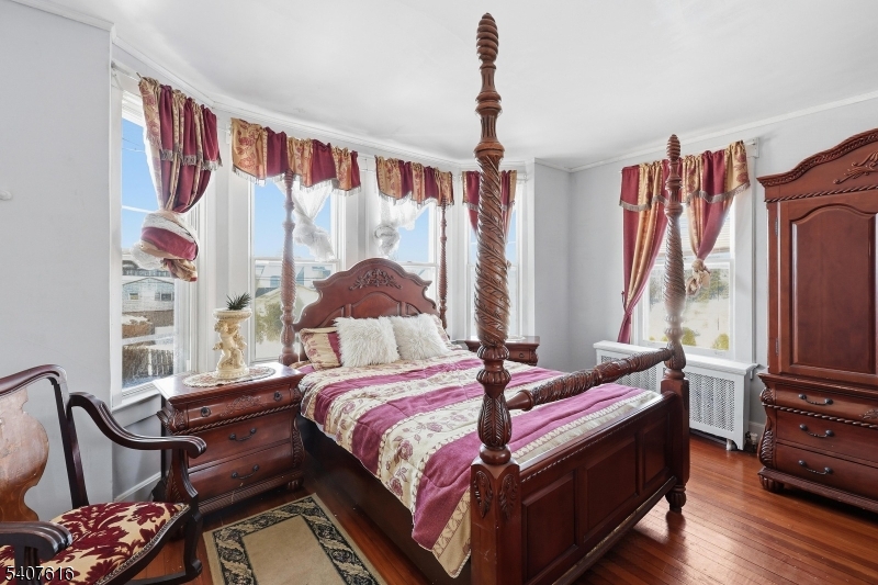 871 Colonia Road Elizabeth, NJ 07208 - Photo 6 of 12 a bedroom with a bed closet and flat tv screen