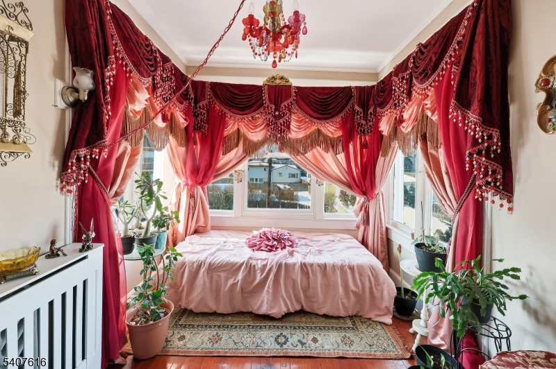 871 Colonia Road Elizabeth, NJ 07208 - Photo 7 of 12 a bedroom with a bed and a potted plant