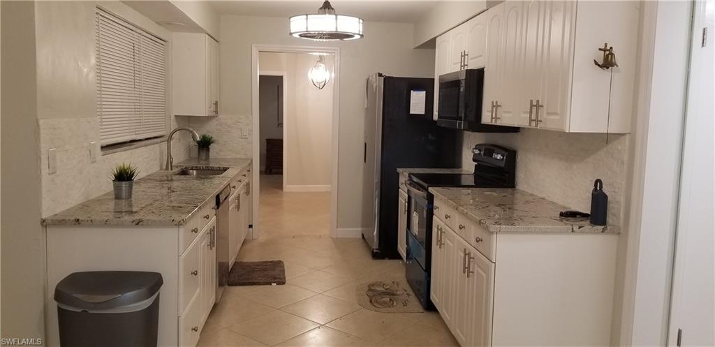 4201 23rd Place Southwest Naples, FL 34116 - Photo 1 of 19 a kitchen with a refrigerator sink and stove