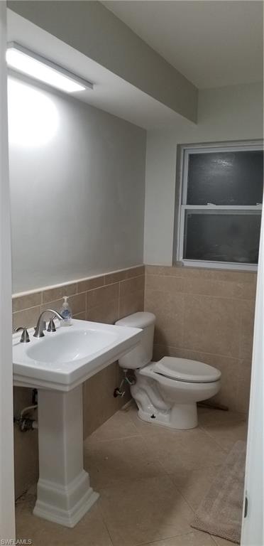 4201 23rd Place Southwest Naples, FL 34116 - Photo 12 of 19 a bathroom with a sink toilet and mirror