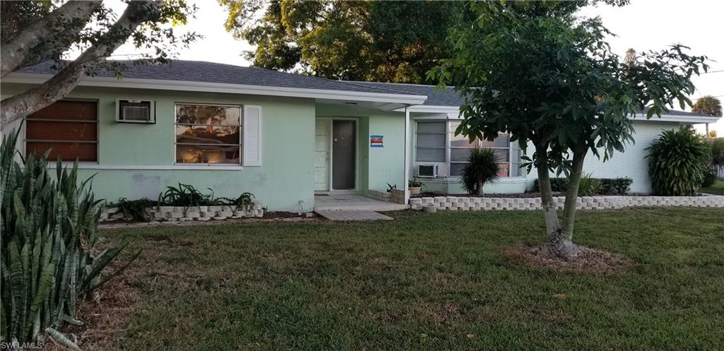 4201 23rd Place Southwest Naples, FL 34116 - Photo 2 of 19 a front view of a house with a garden