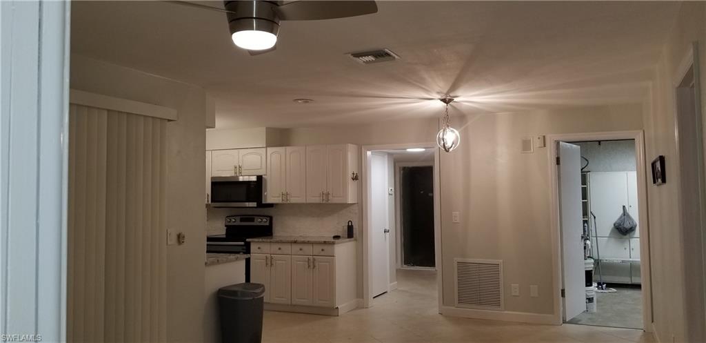 4201 23rd Place Southwest Naples, FL 34116 - Photo 3 of 19 a kitchen with a refrigerator and a sink