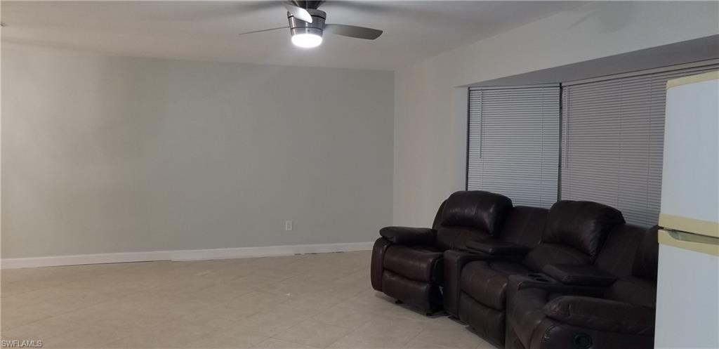 4201 23rd Place Southwest Naples, FL 34116 - Photo 7 of 19 a living room with furniture and stairs