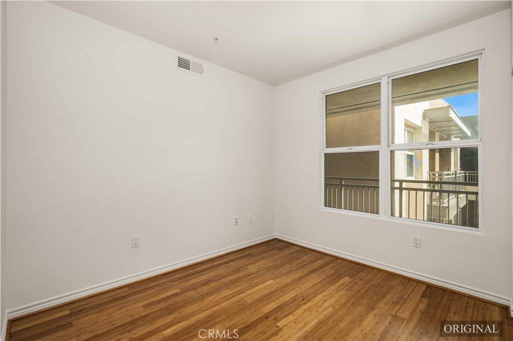 85 East Commonwealth Avenue, Unit 3D Alhambra, CA 91801 - Photo 22 of 30 a view of empty room with wooden floor and fan