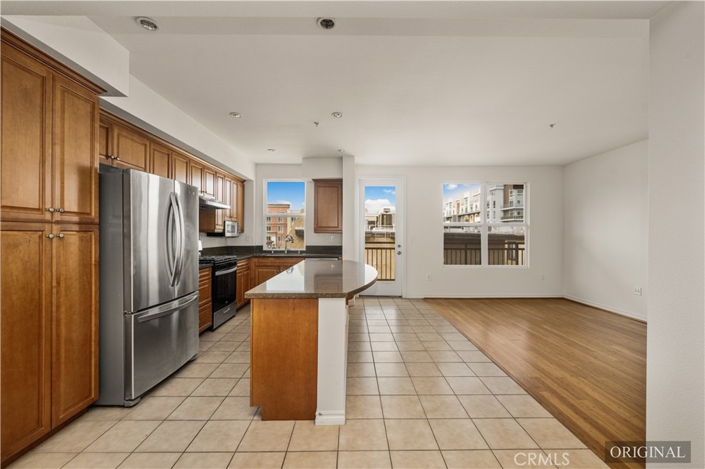 85 East Commonwealth Avenue, Unit 3D Alhambra, CA 91801 - Photo 9 of 30 a kitchen with refrigerator cabinets and stainless steel appliances
