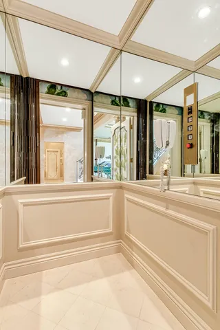 a large kitchen with white cabinets a sink dishwasher a stove and a dining table with wooden floor