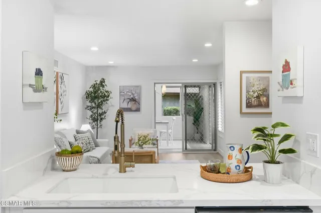 a dining room with furniture and potted plant