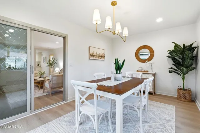 a view of a dining room with furniture and a chandelier